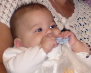 This is Boo.  This is Boos' Catholic baptism.  This is Boo at his baptism being held by his Godmother.  This is Boo being held by his Godmother while I am sitting next to her also in the picture.  